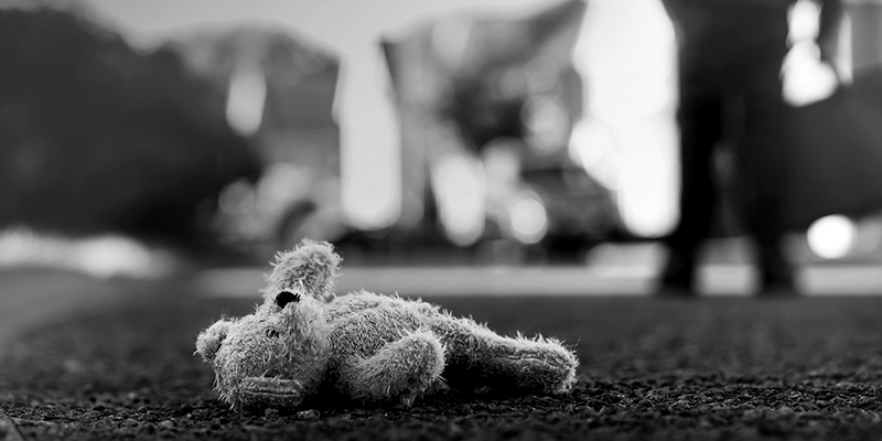 Foto em preto e branco de urso de pelúcia jogado no chão